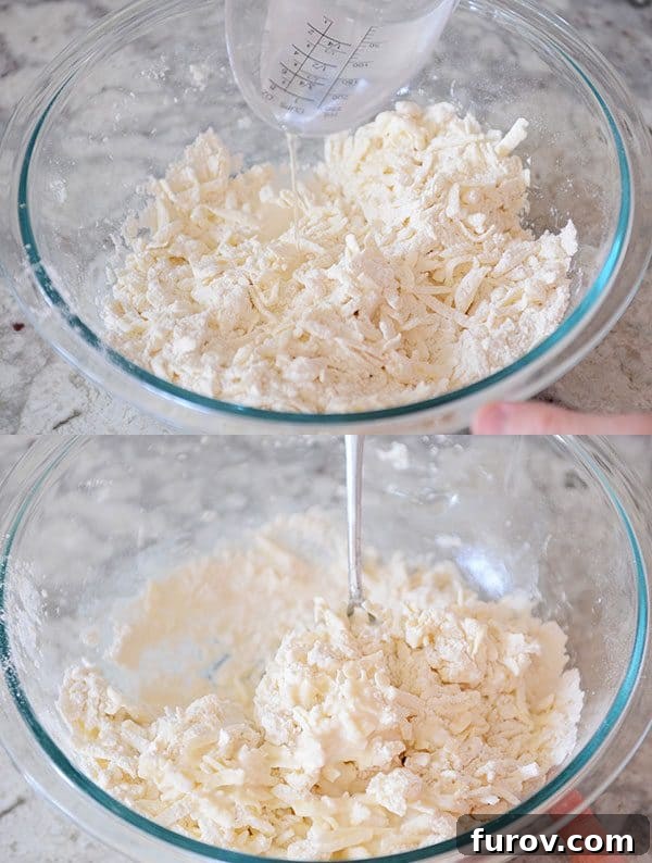 Unlock the Secret to Flaky Homemade Pie Crust 10 Cold water being drizzled into the pie dough ingredients in a glass bowl.