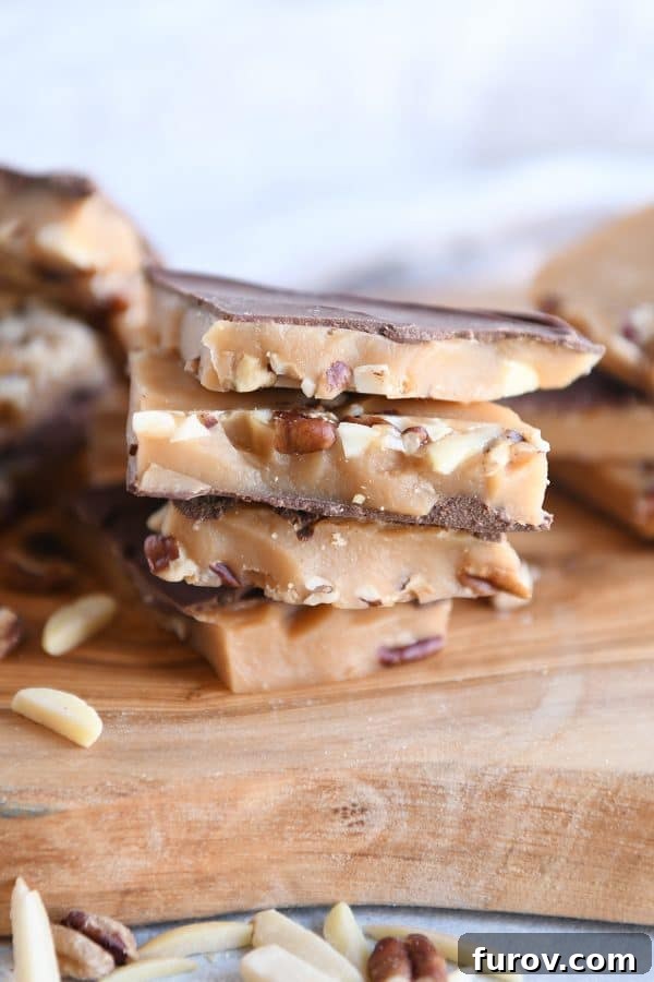 Golden homemade toffee cooling on parchment-lined baking sheet, ready to be broken into pieces.