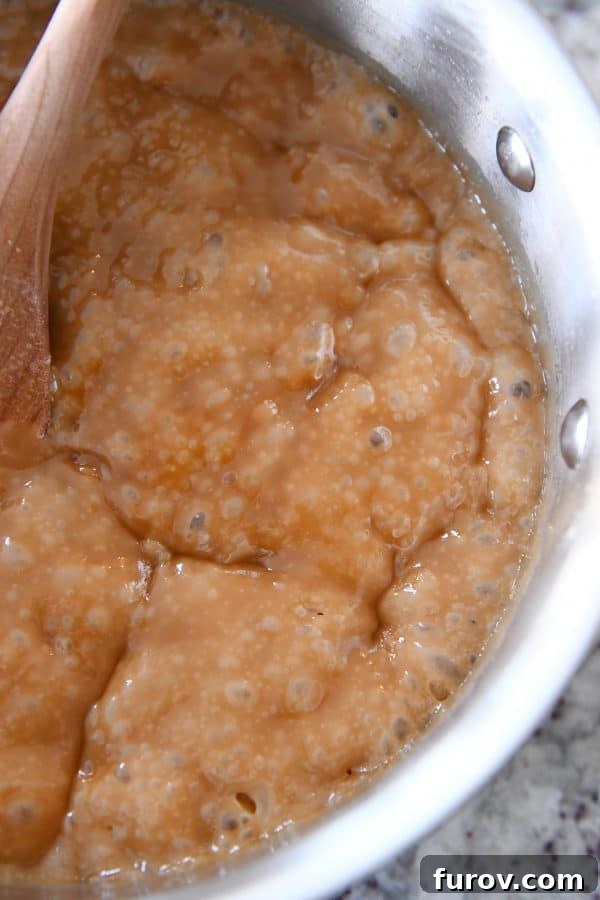 Cooked homemade toffee in a stainless steel saucepan, ready to be poured.