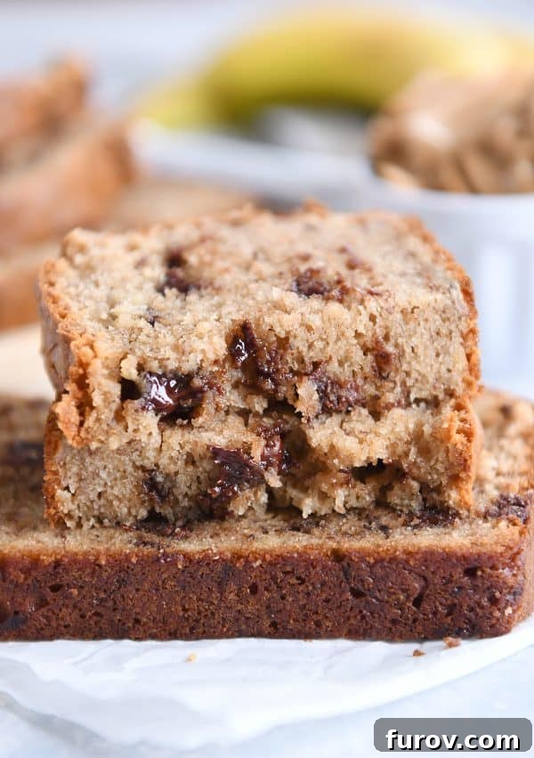 Three slices of peanut butter banana bread on white napkin.