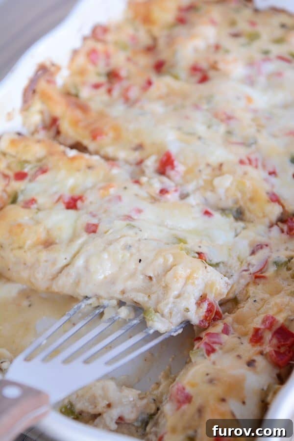 Velvet Shrimp Enchiladas Blanco 3 Golden-baked shrimp enchiladas resting in a white ceramic baking dish, ready to be served.