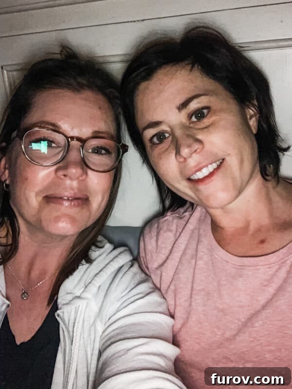 Two friends taking a selfie, smiling brightly