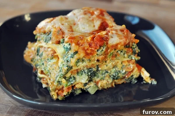 A close-up of a delectable slice of veggie lasagna, highlighting its rich, cheesy layers and fresh ingredients.
