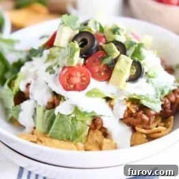 Elevated Taco Bowls with Zesty Creamy Lime Dressing Stovetop or Slow Cooker 9 A vibrant Floating Taco Bowl, generously topped with fresh ingredients and creamy lime dressing.