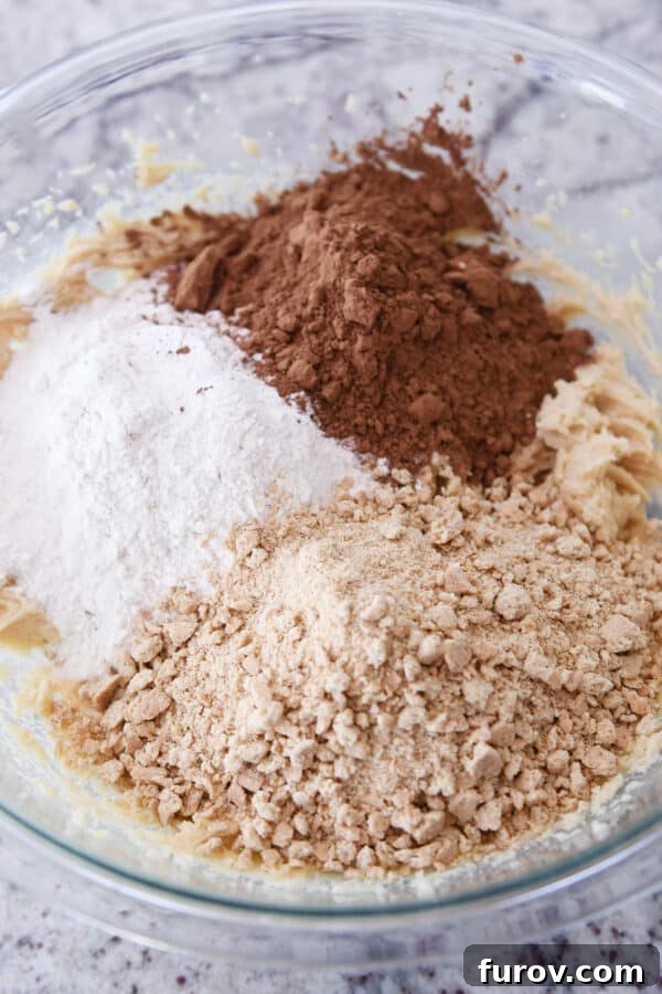 Flour, cocoa powder, and graham cracker crumbs in glass bowl.