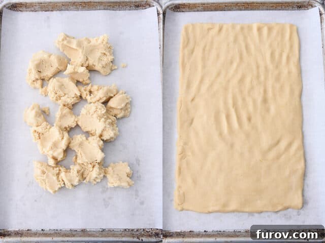 sugar cookie dough crumbled on parchment lined sheet pan and then pressed into rectangle shape