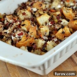 Wild Rice and Creamy Goat Cheese Stuffing in a white dish, ready to serve.