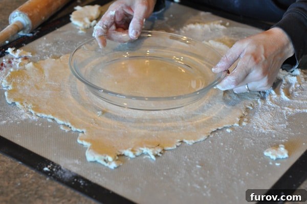 rolled out pie crust with a pie dish over the top, for size check.