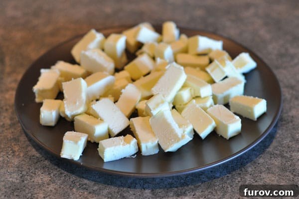 cubed up butter on a black plate, ready for chilling.
