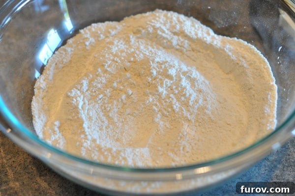 flour in a glass bowl, ready for mixing.
