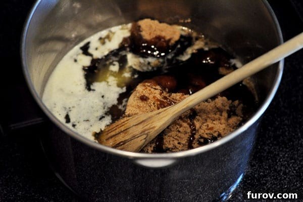 A saucepan filled with a mixture of brown sugar and corn syrup, ready to be heated and transformed into rich caramel.