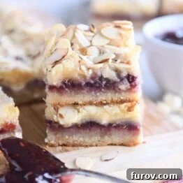 Luscious Raspberry White Chocolate Blondies 7 two raspberry white chocolate blondie bars on wood cutting board