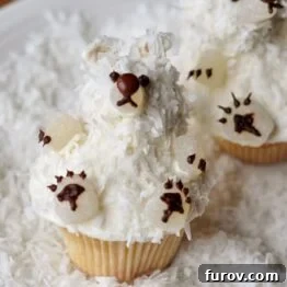 Perfectly baked vanilla buttermilk cupcake with a swirl of creamy frosting.