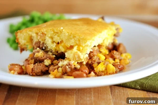 Bean and corn cornbread-topped dinner on a white plate.