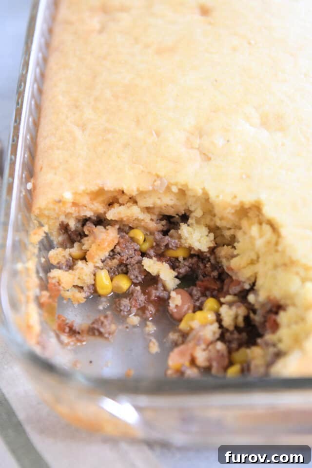 Glass 9X13-inch pan with beef, bean, corn, salsa and cornbread.