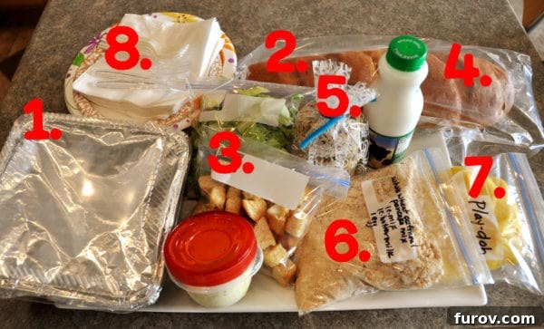 A white tray organized with various food containers, each clearly numbered in red, illustrating the components of a comprehensive take-in meal.