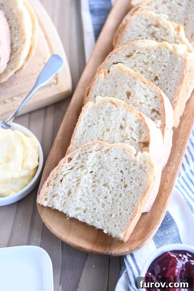 Six half slices of sourdough peasant bread on wooden tray.