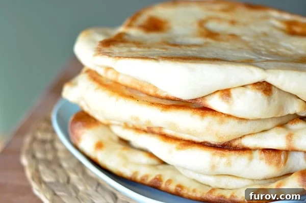 A blue plate with stacked cooked flatbread.