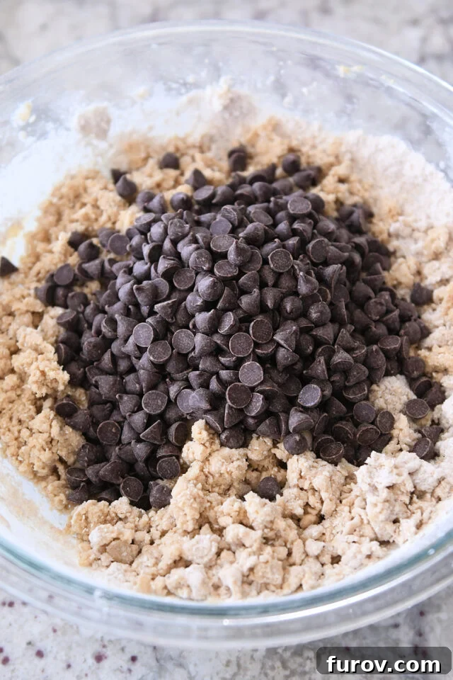 Glass bowl with cookie dough and chocolate chips.