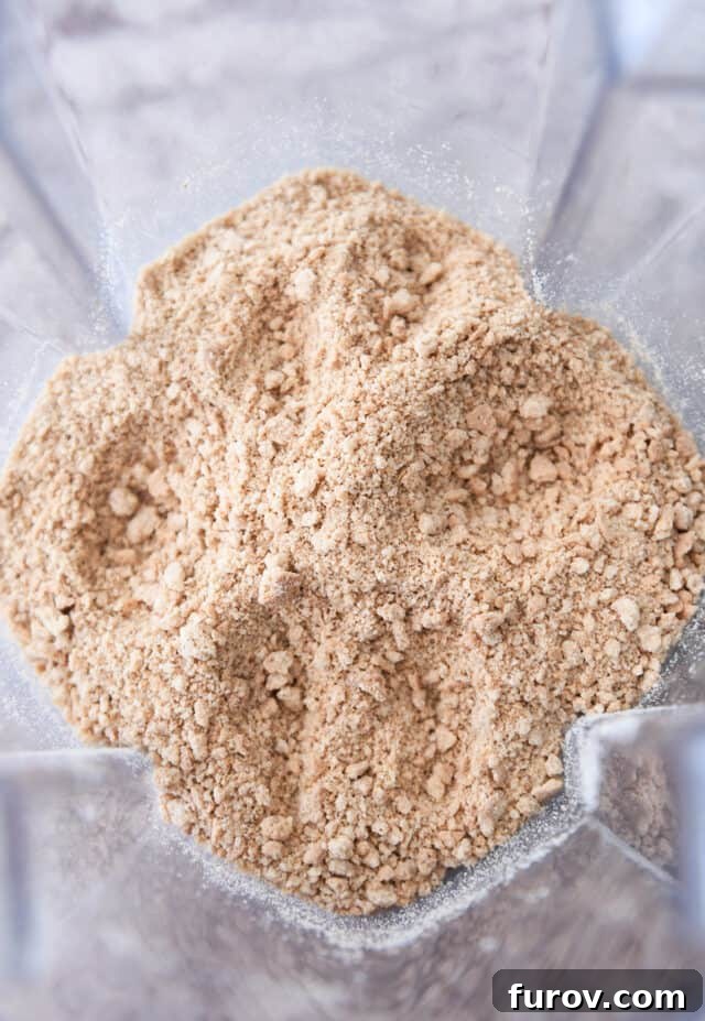 Crisp, Buttery Graham Cracker Crust 3 A blender filled with freshly crushed graham cracker crumbs, illustrating the perfect texture ready for mixing.