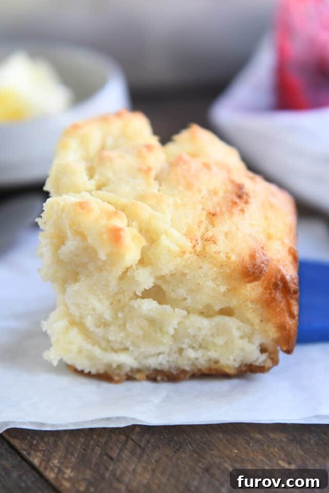 A fluffy Butter Swim Biscuit with perfectly golden, buttery edges, resting on parchment paper, ready to be served.