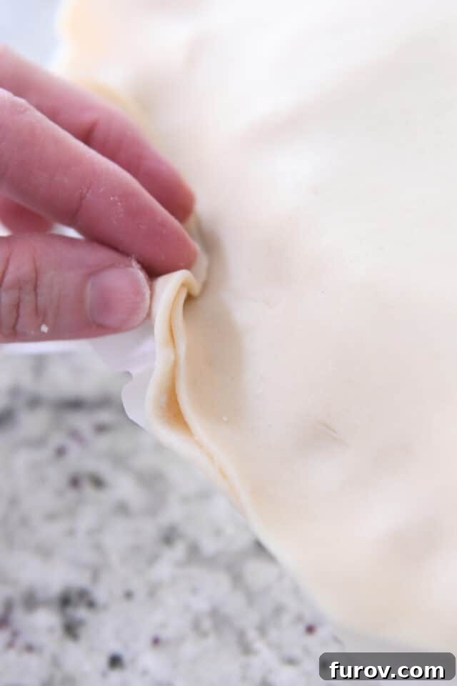 Folding over bottom pie crust.