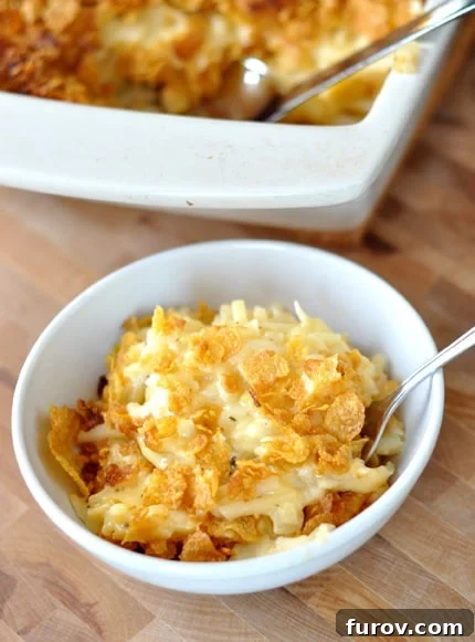 A beautifully presented white bowl of Cheesy Au Gratin Potatoes, ready to be served.