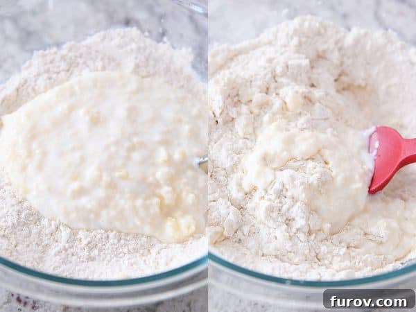 Rubber spatula mixing the buttermilk and butter mixture into the dry ingredients for buttermilk drop biscuits.