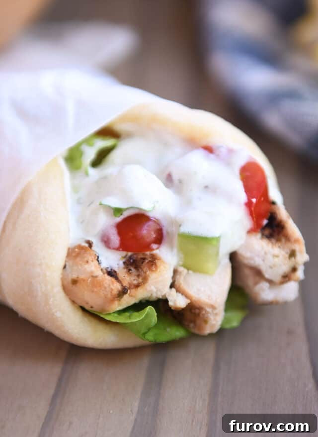 Ultimate Easy Chicken Gyros 2 Flavorful chicken gyro wrapped in soft flatbread, ready to be enjoyed.