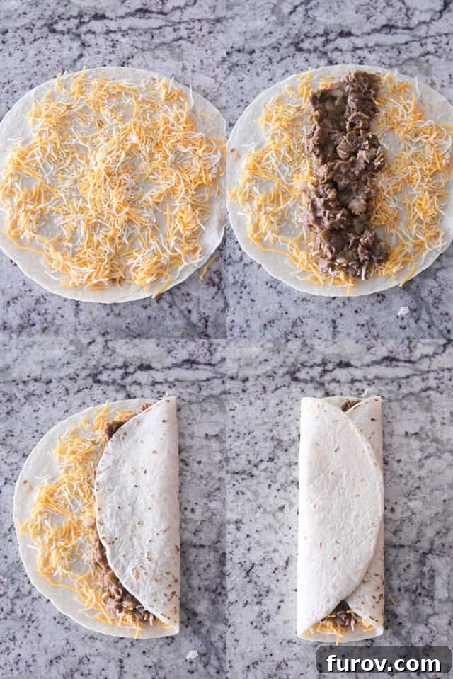 Hands carefully assembling beef and bean wraps, layering cheese and filling onto a tortilla before folding.