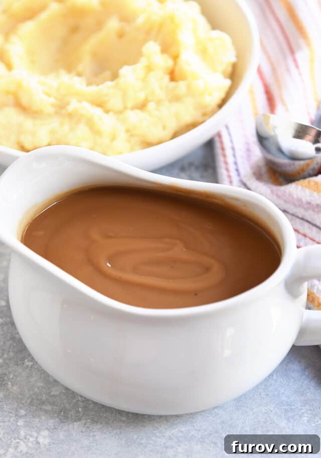 Gravy boat filled with brown gravy.