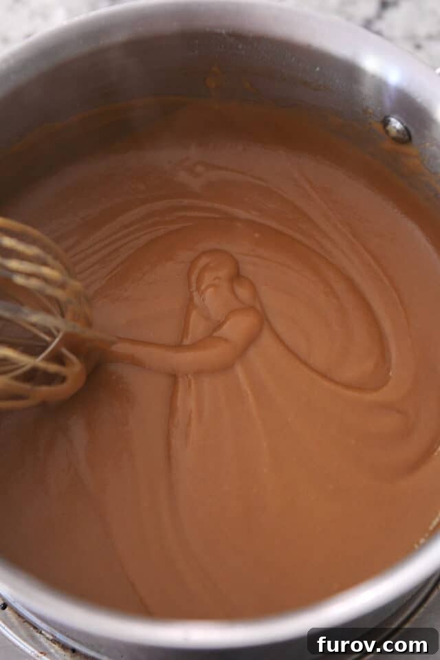Whisk swirling gravy in saucepan.