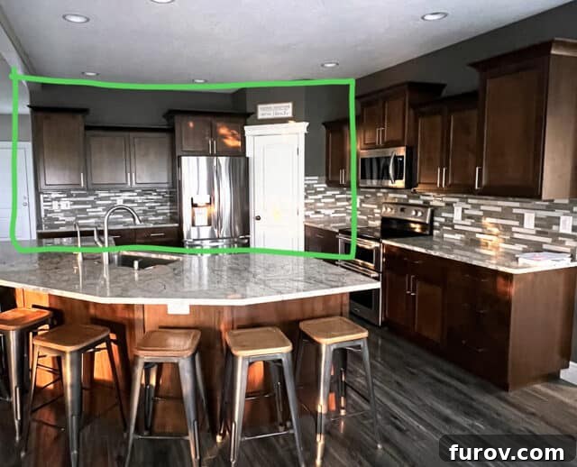 An architectural plan highlighting a wall in green that is slated for removal to expand the kitchen area, demonstrating the planned renovation.