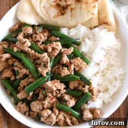 20-Minute Thai Turkey & Green Bean Dinner 9 Top down view of ground turkey, green beans, rice and naan bread in white bowl.