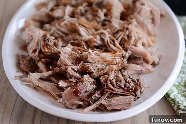 A close-up view of the shredded pork with a glistening balsamic glaze, ready to be enjoyed, highlighting the rich texture.