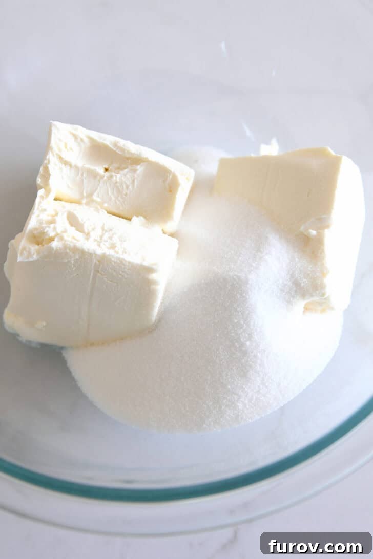 Irresistible Bite-Sized Cheesecakes 5 Cream cheese and granulated sugar in glass bowl.