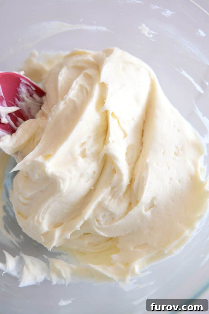 Irresistible Bite-Sized Cheesecakes 6 Whipped cream cheese and sugar in glass bowl.