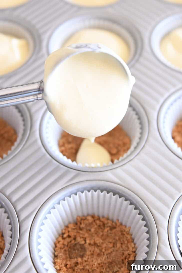 Irresistible Bite-Sized Cheesecakes 9 Scooping cheesecake batter into muffin liners with graham cracker crust.