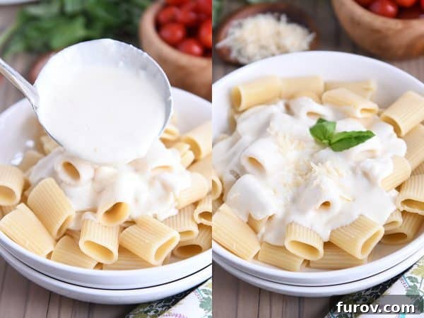 Rich homemade Alfredo sauce is poured generously over perfectly cooked rigatoni pasta, highlighting the creamy texture and appetizing appeal of the dish.