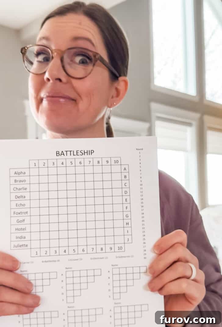 Pencil & Paper Naval Strategy 2 Woman holding paper battleship game.