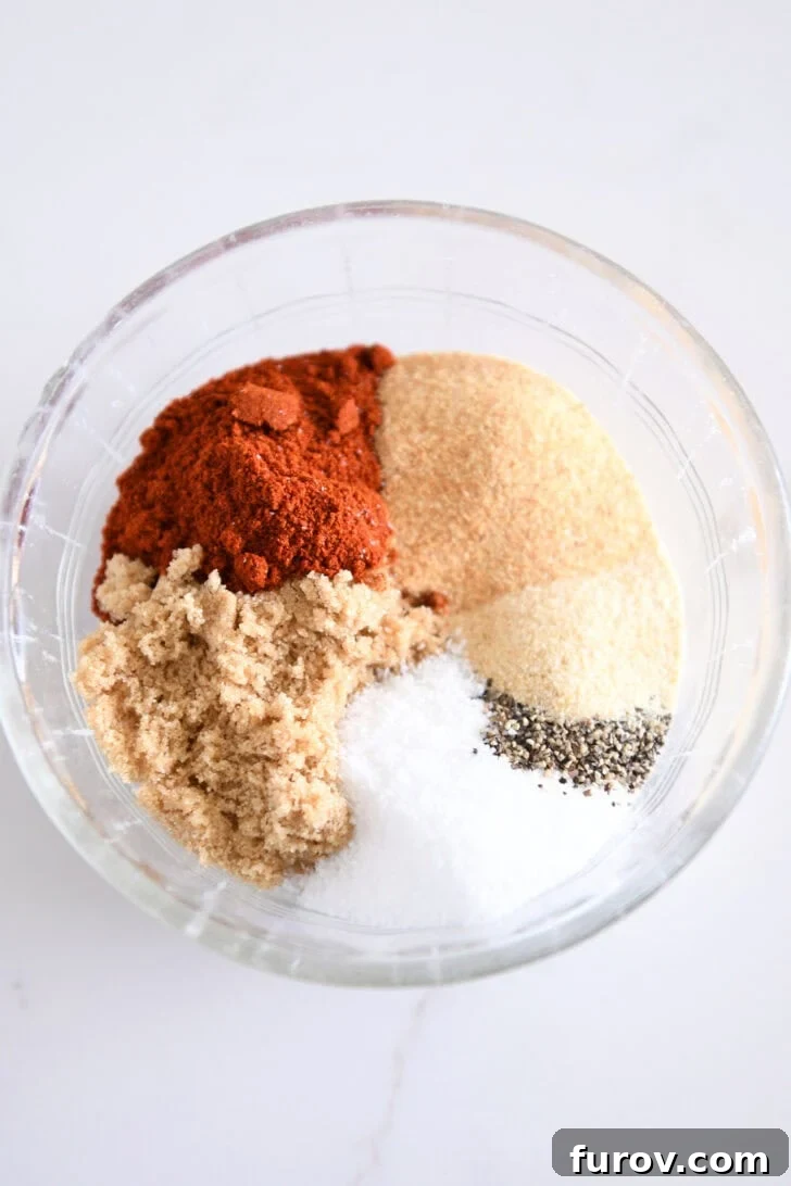 Speedy and Succulent Air Fryer Pork Tenderloin 3 A glass bowl filled with the homemade spice rub mixture, including smoked paprika, garlic powder, onion powder, brown sugar, salt, and pepper.