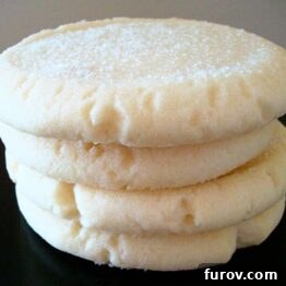 Crystal Confections 4 Sugar Gems cookies, a stack of them on a black plate, some frosted.