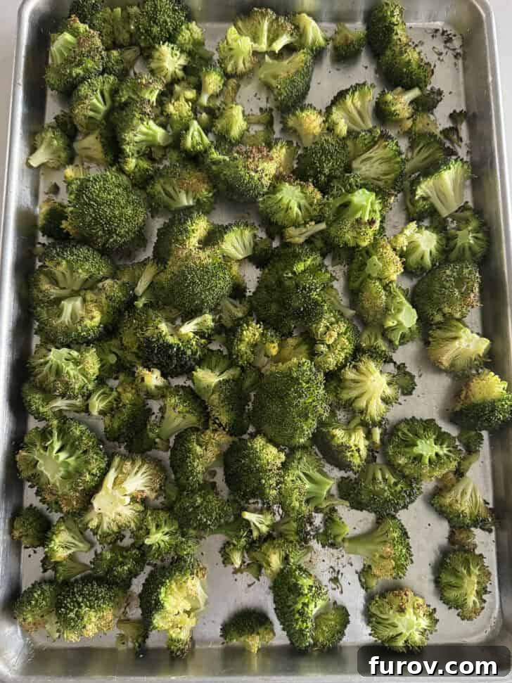 Sheet pan with roasted broccoli.