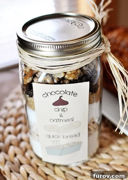 Homemade Oatmeal Chocolate Chip Jar Quick Bread 2 Mason jar with layered dry ingredients for oatmeal chocolate chip quick bread, ready to be gifted or baked.
