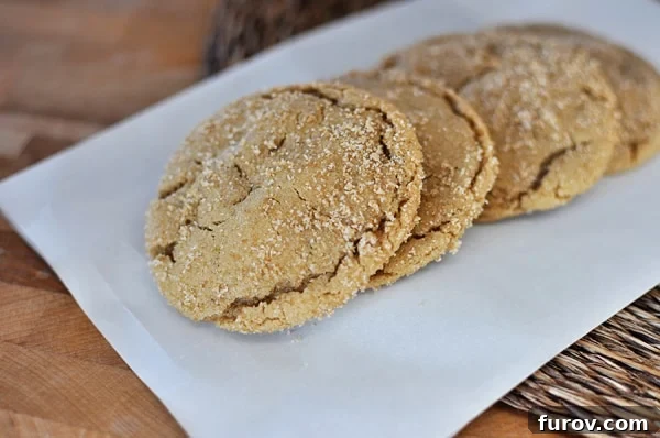 Chewy Brown Sugar Crinkle Cookies 3 Four perfectly baked brown sugar crackle cookies lined up in a row, highlighting their appealing crackled surfaces and soft centers.