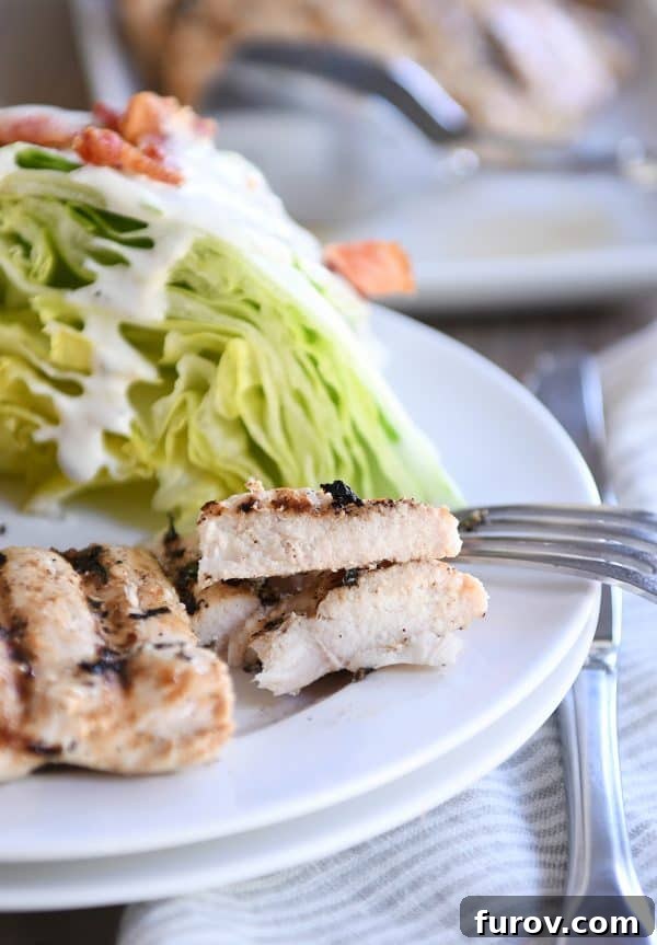 Perfectly grilled lemon garlic chicken cut into savory pieces on a white plate, ready to be enjoyed.