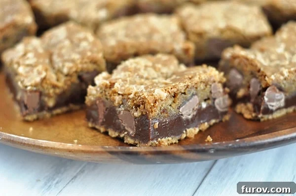 Decadent Toffee Chocolate Chip Cookie Slabs 3 A stunning plate showcasing several neatly cut squares of fudge-filled chocolate chip cookie bars, ready to serve.