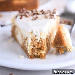 Slice of carrot cake cheesecake on white plate with fork.