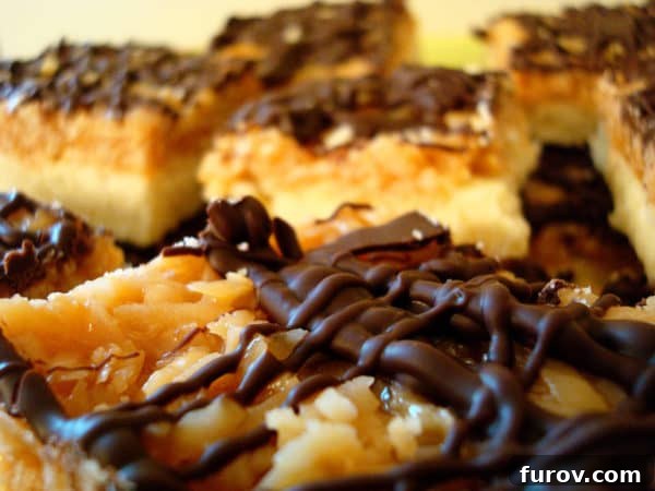 Display of neatly cut Samoas bars, showing the shortbread, caramel, coconut, and chocolate layers.