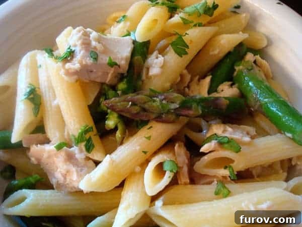 Garlicky Tuna Asparagus Pasta 2 A beautifully plated bowl of garlic tuna pasta with fresh asparagus spears, ready for a light spring dinner.